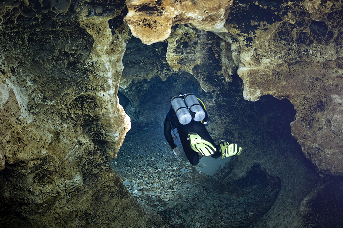 My cave diving buddy Pierce Hoover leads the way to. the Bone Room inside  Ginnie Springs Devil's Ear  cave system.
