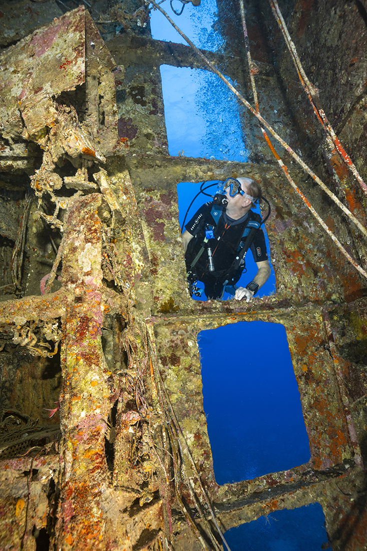 Diver Brad Gehrt peering into the bridge of the Salem Express.