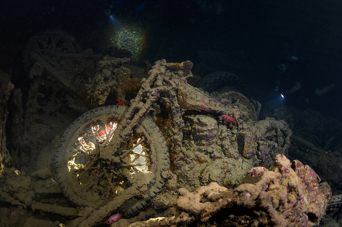The motorcycles in the Thistlegorm's forward hold are fascinating subjects. Lighting is challenging, as the areas below deck receive little natural light. For this photo, a bright video light was creatively placed opposite the bike’s front tire.