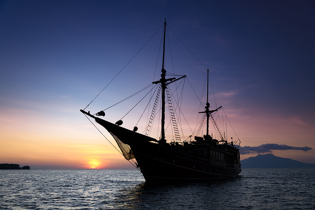 Dive liveaboard Arenui coming up to Kalabahi Bay on the western end of Indonesia's Alor Island just ahead of a planned night dive.